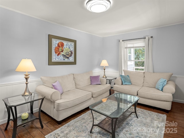 living room with ornamental molding and wood finished floors