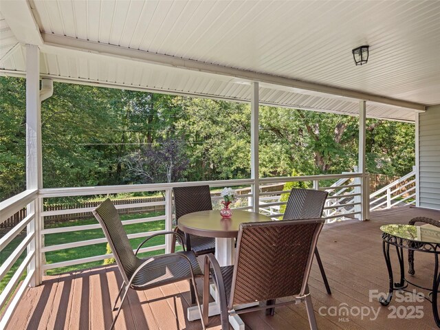 wooden terrace with outdoor dining space