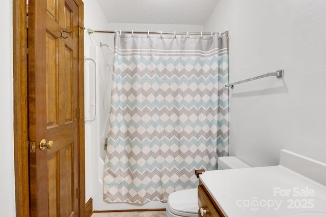full bathroom featuring toilet, a textured ceiling, vanity, and shower / bath combo