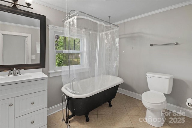 bathroom with toilet, baseboards, a freestanding bath, and crown molding