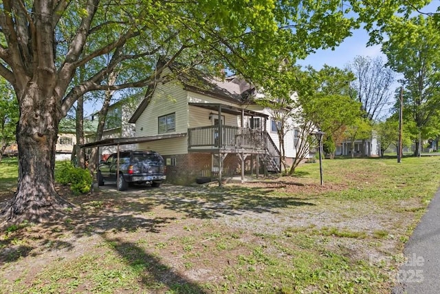 exterior space with a lawn, stairs, and a carport