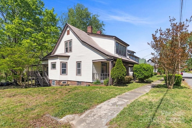 view of property exterior with a chimney, a wooden deck, stairway, and a yard