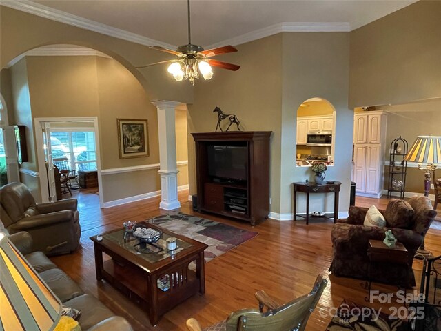 121 General Pemberton St, Stanley, NC 28164 - living room featuring arched walkways, baseboards, wood finished floors, and ceiling fan