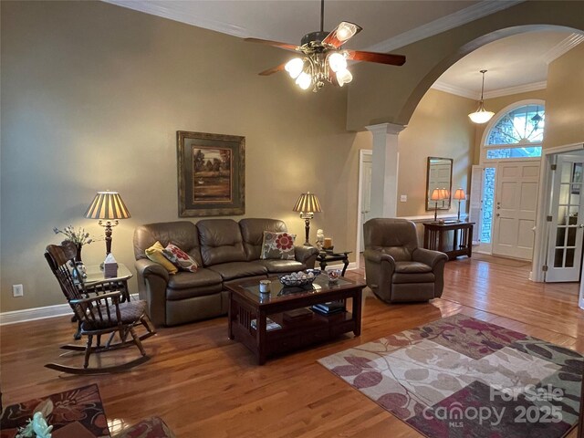 121 General Pemberton St, Stanley, NC 28164 - living area with arched walkways, ceiling fan, crown molding, and wood finished floors