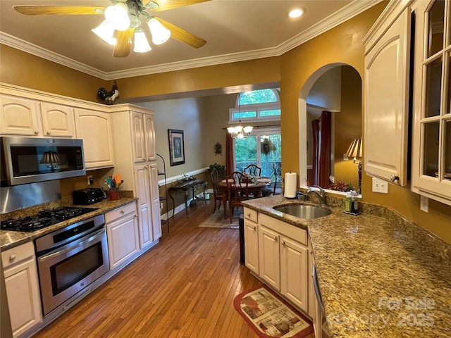 121 General Pemberton St, Stanley, NC 28164 - kitchen featuring crown molding, ceiling fan with notable chandelier, light wood-style flooring, appliances with stainless steel finishes, and a sink