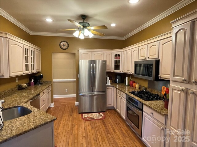 121 General Pemberton St, Stanley, NC 28164 - kitchen featuring crown molding, appliances with stainless steel finishes, and glass insert cabinets
