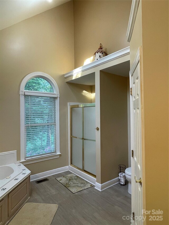 121 General Pemberton St, Stanley, NC 28164 - bathroom with a shower stall, visible vents, toilet, wood finished floors, and baseboards
