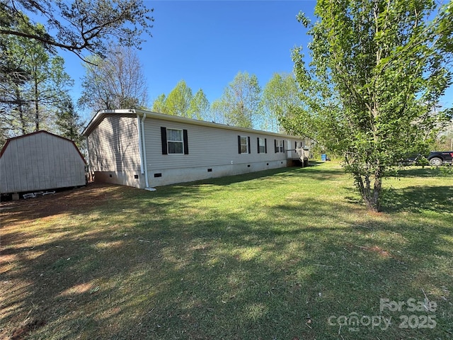 2084 Bristol Creek Ave, Morganton, NC 28655 - back of property featuring a yard, crawl space, an outdoor structure, and a storage unit