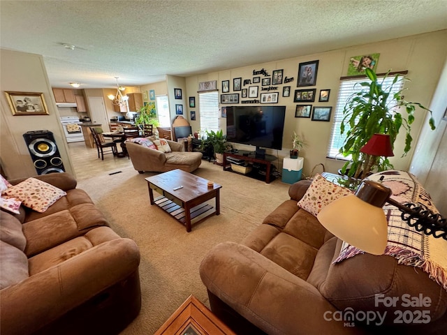 2084 Bristol Creek Ave, Morganton, NC 28655 - living room with a textured ceiling, a notable chandelier, and light carpet