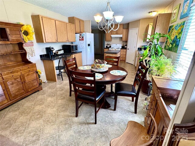2084 Bristol Creek Ave, Morganton, NC 28655 - dining space with light tile patterned flooring, a textured ceiling, and a notable chandelier