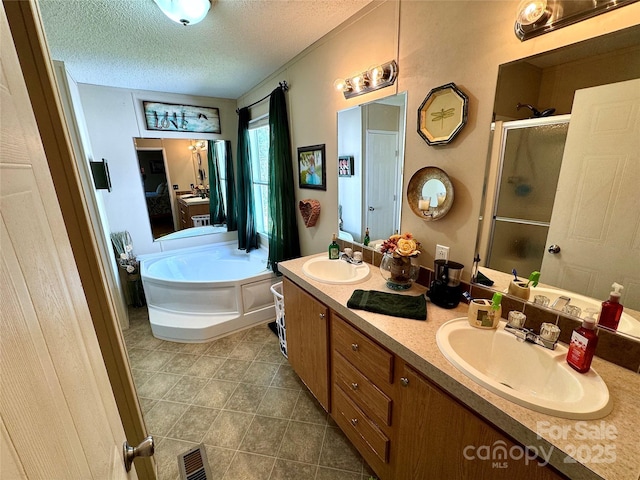 2084 Bristol Creek Ave, Morganton, NC 28655 - bathroom featuring a sink, a textured ceiling, a shower stall, and double vanity