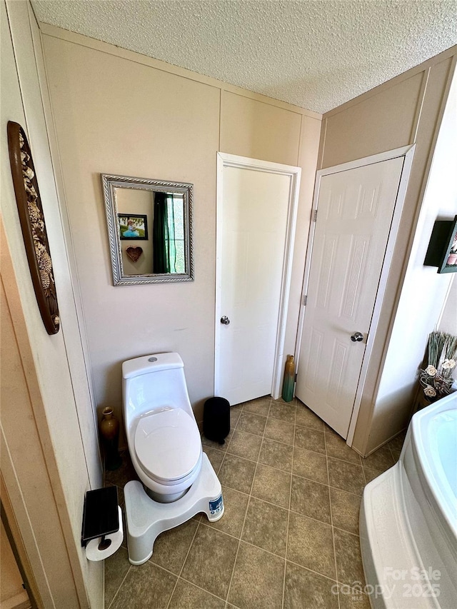 2084 Bristol Creek Ave, Morganton, NC 28655 - bathroom featuring tile patterned flooring, toilet, and a textured ceiling