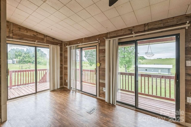 7527 Old Shelby Rd, Vale, NC 28168 - spare room with wooden walls, wood finished floors, and vaulted ceiling