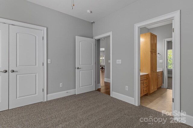 7748 Long Bay Pkwy, Catawba, NC 28609 - unfurnished bedroom featuring light carpet, baseboards, and connected bathroom