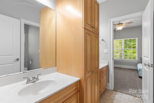 7748 Long Bay Pkwy, Catawba, NC 28609 - bathroom featuring a ceiling fan, vanity, toilet, tile patterned flooring, and baseboards