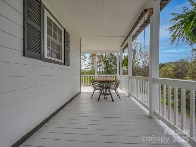 deck with outdoor dining area