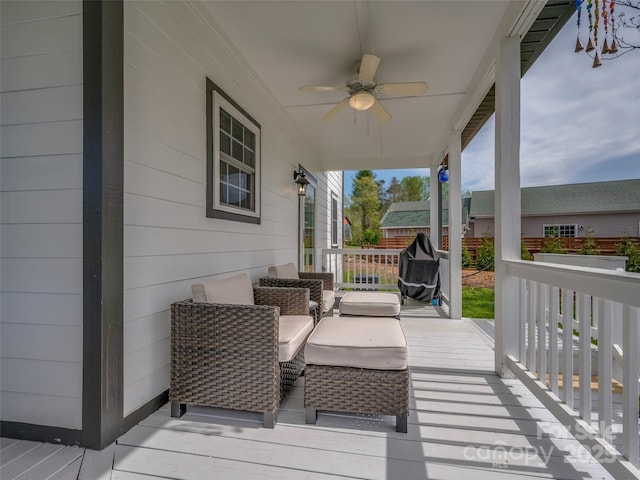 wooden deck featuring a ceiling fan