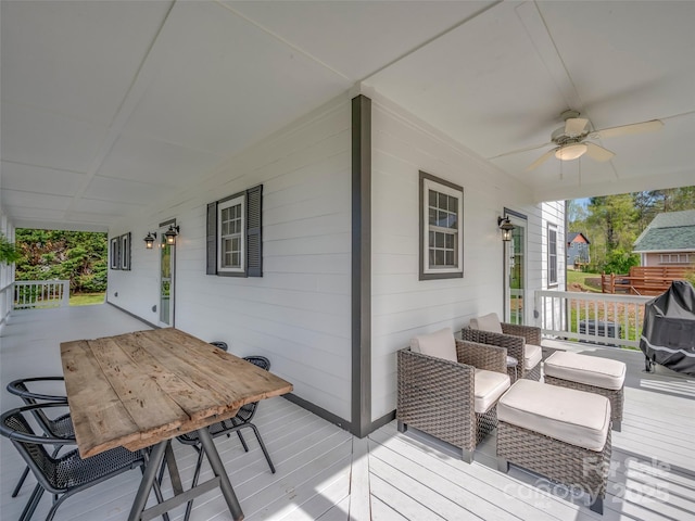 deck featuring outdoor dining space and a ceiling fan