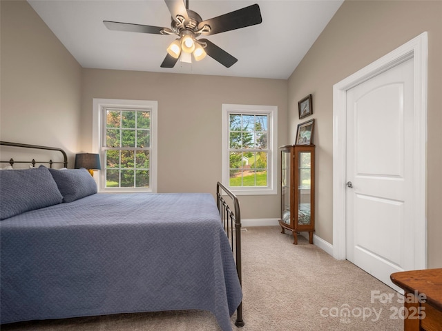 carpeted bedroom with baseboards, multiple windows, and a ceiling fan