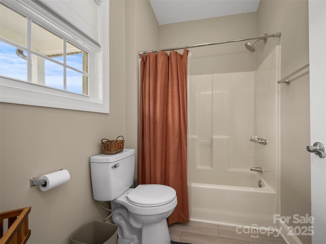 bathroom with toilet and shower / bath combo