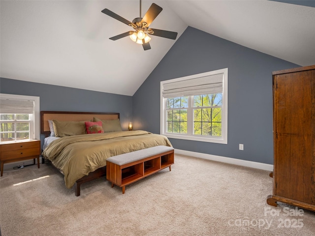 carpeted bedroom featuring a ceiling fan, baseboards, multiple windows, and vaulted ceiling