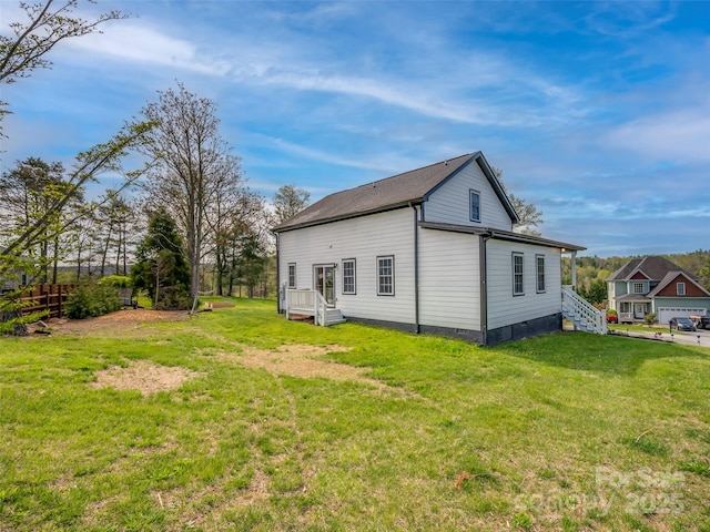 rear view of property with a yard and fence