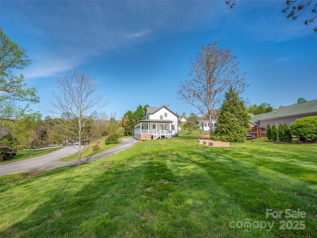 view of yard with a sunroom