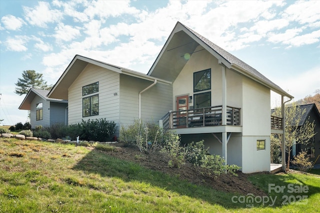 exterior space with a front yard and stucco siding