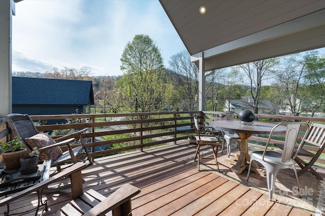 wooden terrace featuring outdoor dining space