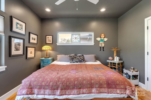 bedroom with baseboards, wood finished floors, and recessed lighting