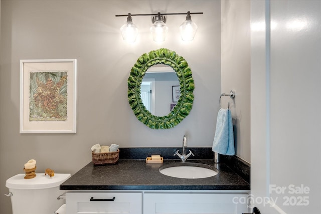 bathroom featuring toilet and vanity