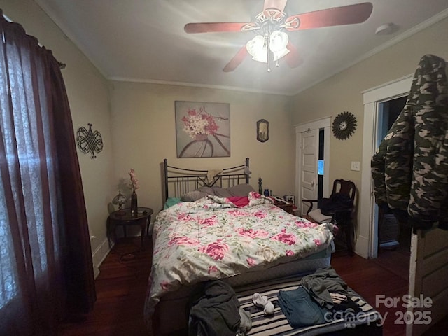 bedroom with a ceiling fan, wood finished floors, and ornamental molding