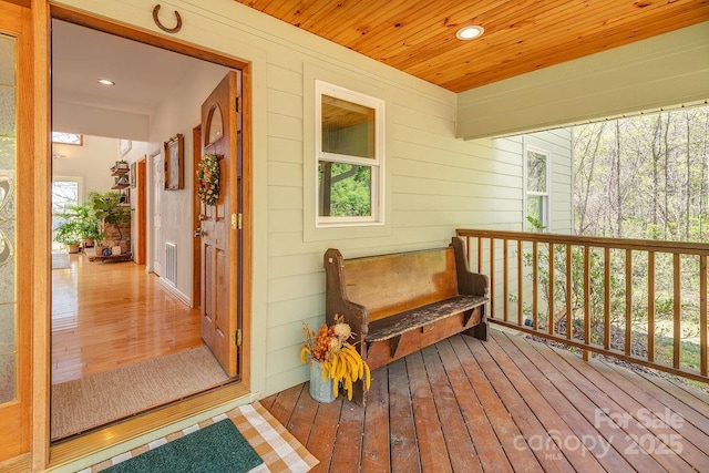 deck with a porch and visible vents