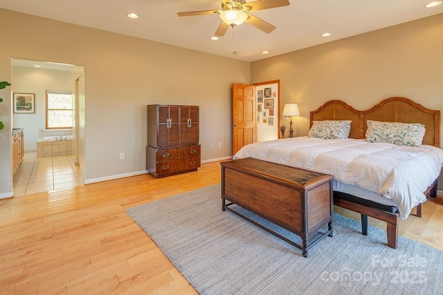 bedroom featuring light wood-style flooring, baseboards, recessed lighting, ceiling fan, and ensuite bath