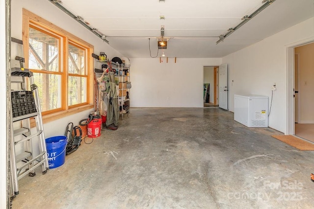 garage with a garage door opener and fridge