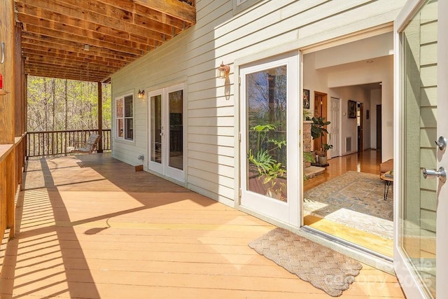 wooden deck featuring french doors and visible vents