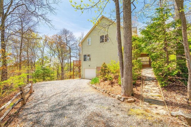 view of side of property featuring driveway and a garage