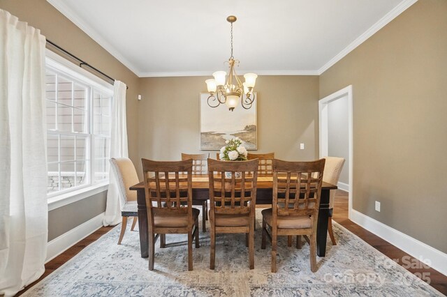 2501 Mt Isle Harbor Dr, Charlotte, NC 28214 - dining room with ornamental molding, baseboards, a notable chandelier, and wood finished floors