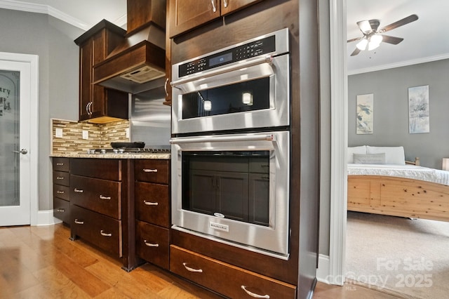 2501 Mt Isle Harbor Dr, Charlotte, NC 28214 - kitchen with stainless steel appliances, a ceiling fan, backsplash, and ornamental molding
