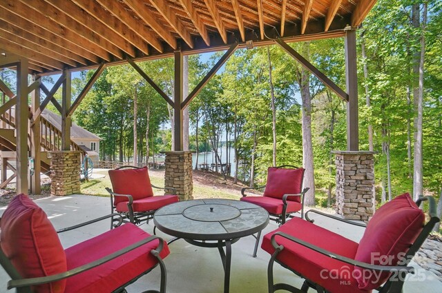 2501 Mt Isle Harbor Dr, Charlotte, NC 28214 - view of patio / terrace featuring a water view, stairway, and an outdoor living space
