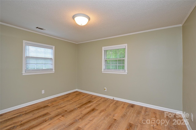 1222 Glenarden Dr, Rock Hill, SC 29730 - unfurnished room featuring light wood-style floors, a textured ceiling, plenty of natural light, and visible vents