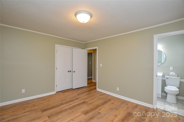 1222 Glenarden Dr, Rock Hill, SC 29730 - unfurnished bedroom featuring a textured ceiling, ornamental molding, ensuite bathroom, and light wood finished floors
