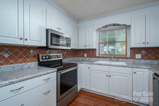 1 Horace Grigg Cir, Shelby, NC 28152 - kitchen with a sink, white cabinetry, crown molding, and stainless steel appliances
