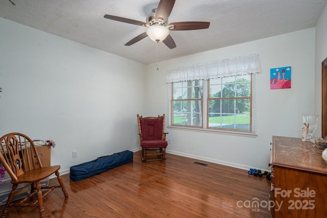 1 Horace Grigg Cir, Shelby, NC 28152 - living area featuring baseboards, a textured ceiling, visible vents, ceiling fan, and wood finished floors