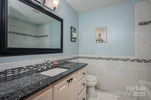 1 Horace Grigg Cir, Shelby, NC 28152 - full bathroom featuring vanity, a textured ceiling, toilet, a tub to relax in, and tile walls