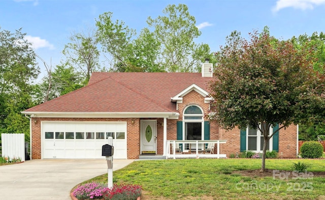 view of front of house with driveway, a chimney, brick siding, a front lawn, and an attached garage