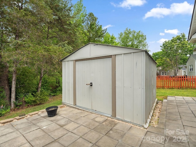 1280 Willowbreeze Ct SW, Concord, NC 28025 - view of shed with fence and an outdoor fire pit