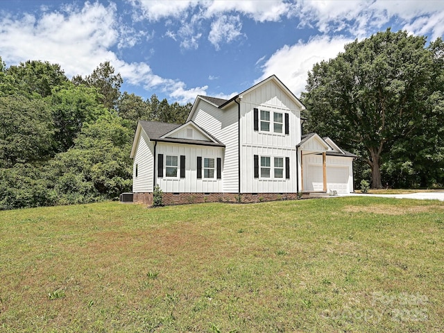 modern farmhouse style home featuring a front lawn, board and batten siding, crawl space, and an attached garage