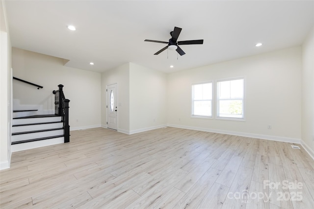 unfurnished living room featuring recessed lighting, stairway, light wood-style flooring, a ceiling fan, and baseboards