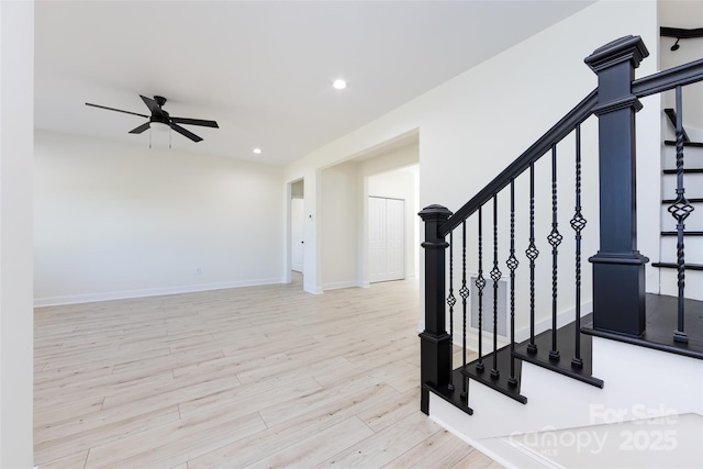 staircase with ceiling fan, recessed lighting, baseboards, and wood finished floors